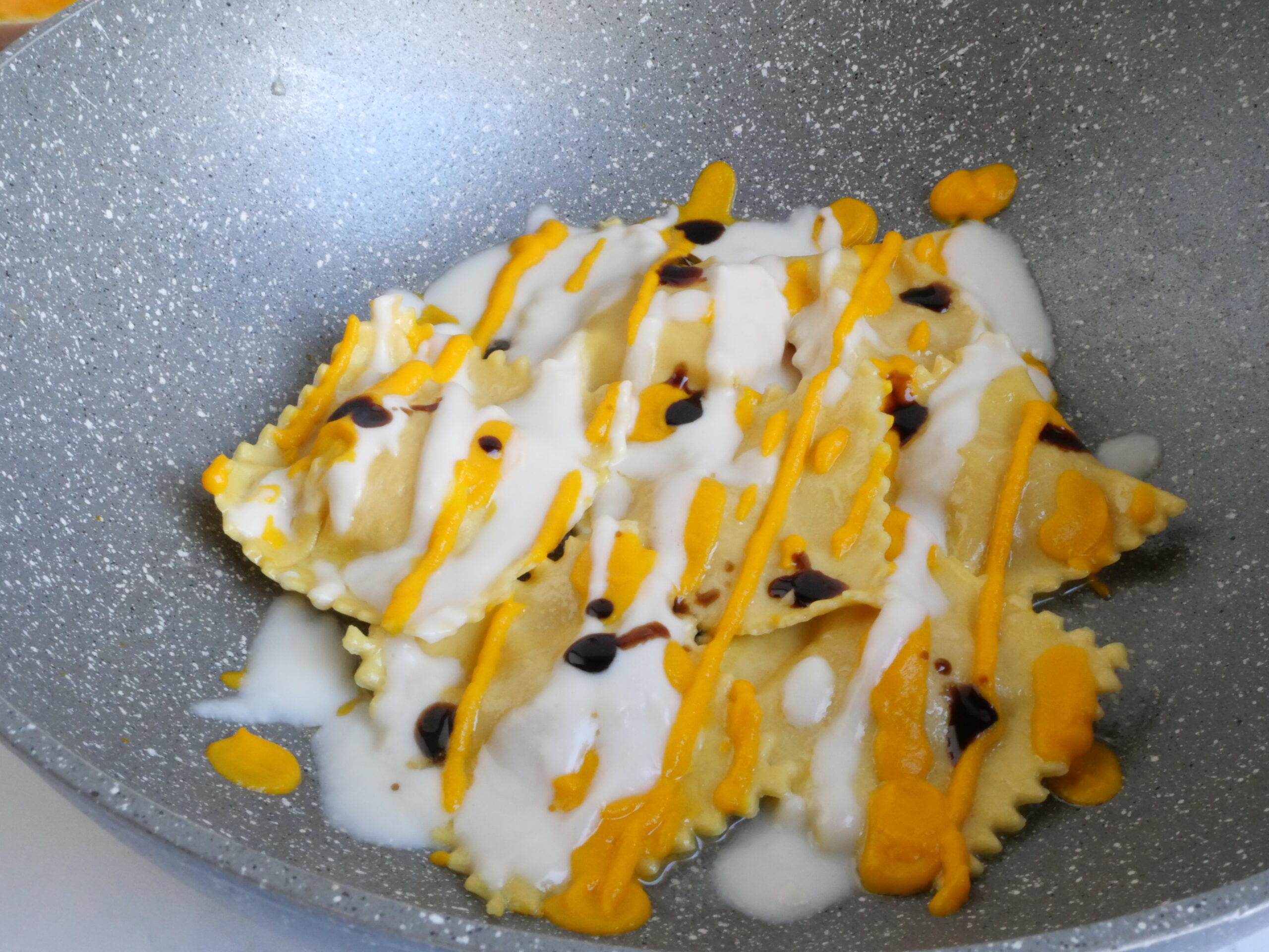 Ravioli alla zucca con crema di Parmigiano Reggiano e Aceto Balsamico di Modena IGP